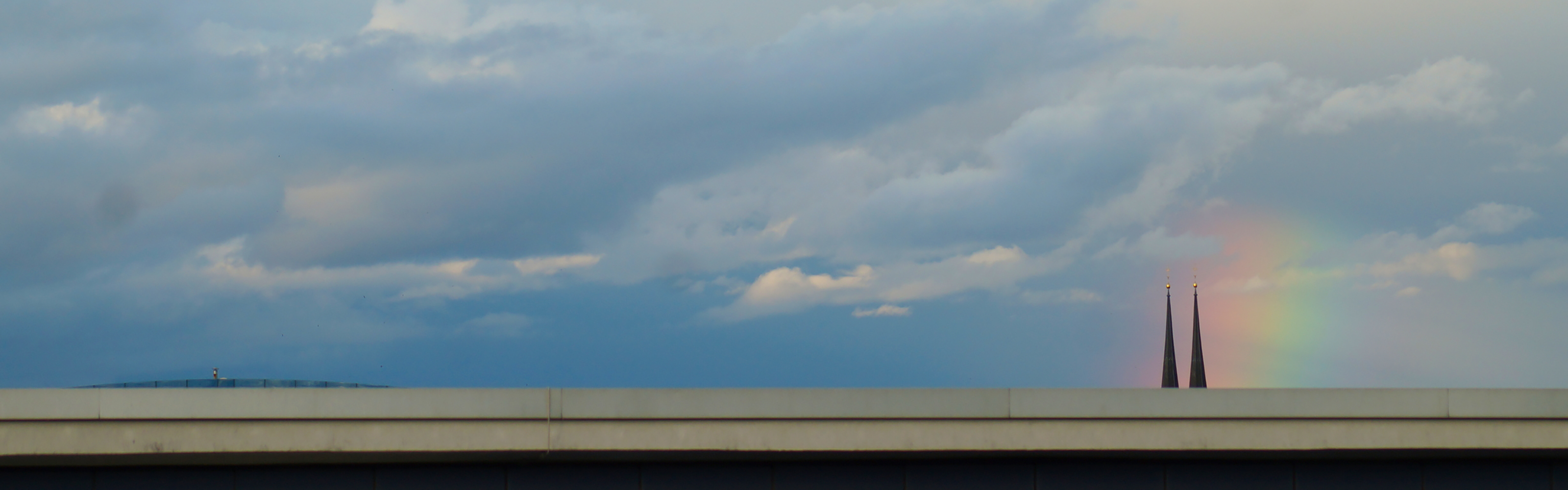 Himmel mit zwei Kirchturmspitzen im Hintergrund